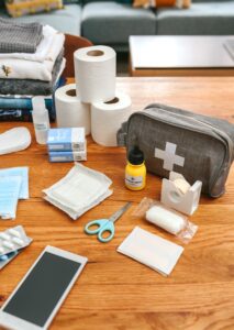 Emergency backpack equipment with first aid kit organized on the table